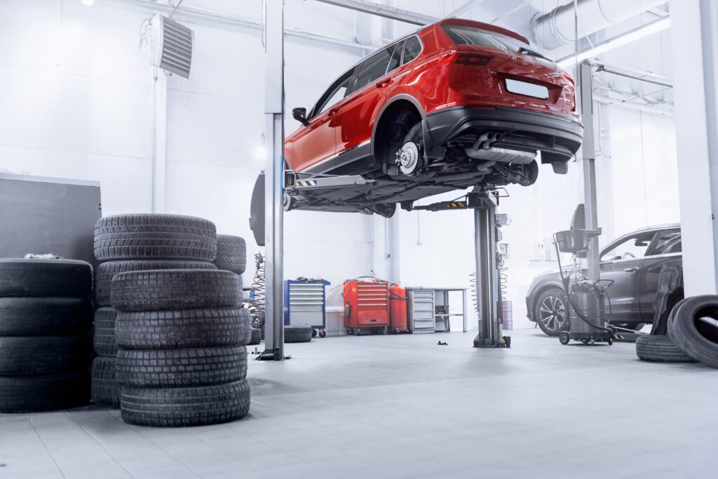 concept,car,wheel,service.,professional,mechanic,changing,tires,in,garage.